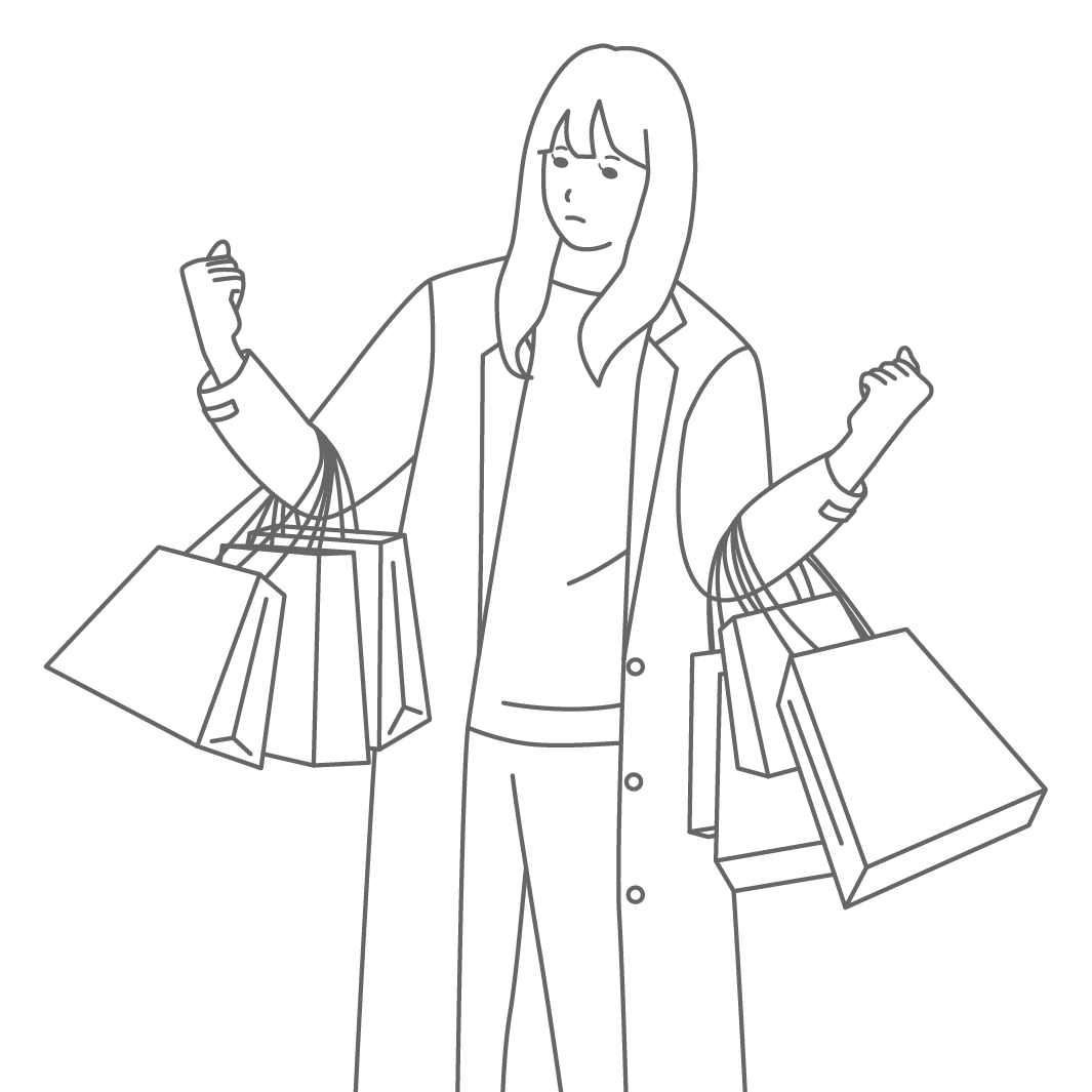 両手に買い物バッグをたくさんかかえた女性